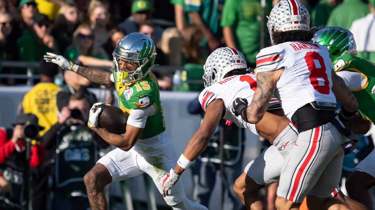 Oregon wide receiver Tez Johnson attempts to avoid a pack of Ohio State defenders as the Oregon Ducks face the Ohio State Buckeyes Wednesday, Jan. 1, 2025, in the quarterfinal of the College Football Playoff at the Rose Bowl in Pasadena, Calif.