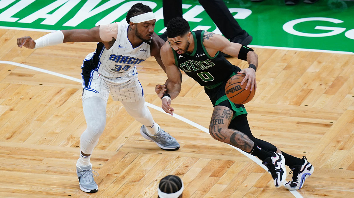 Boston Celtics forward Jayson Tatum (0) drives the ball against Orlando Magic center Wendell Carter Jr. (34) in the first quarter during game five of first round for the 2025 NBA Playoffs at TD Garden.