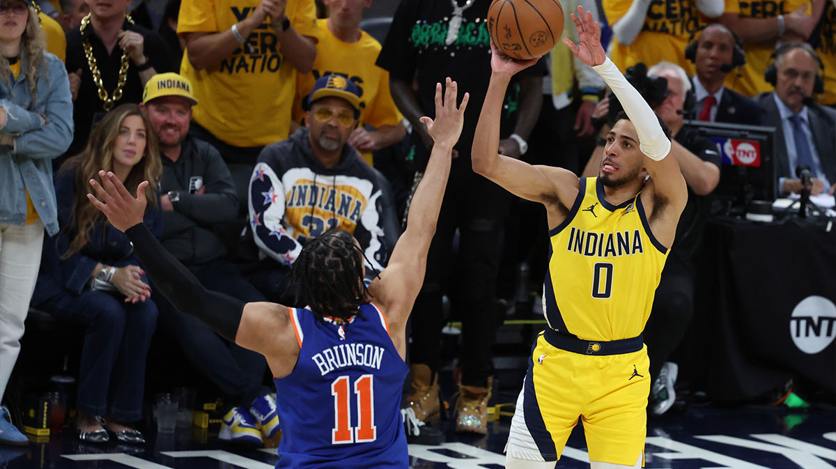 Indiana Pacers guard Tyrese Haliburton (0) shoots a three point basket over New York Knicks guard Jalen Brunson (11) during the fourth quarter of game four of the eastern conference finals for the 2025 NBA Playoffs at Gainbridge Fieldhouse.