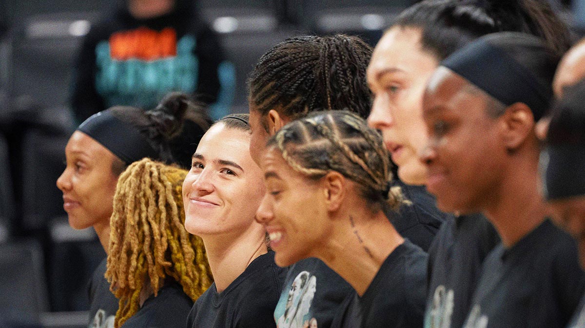 Sabrina Ionescu, center left, looks up at the sold-out crowd at Matthew Knight Arena during the National Anthem May 12, 2025 in Eugene.