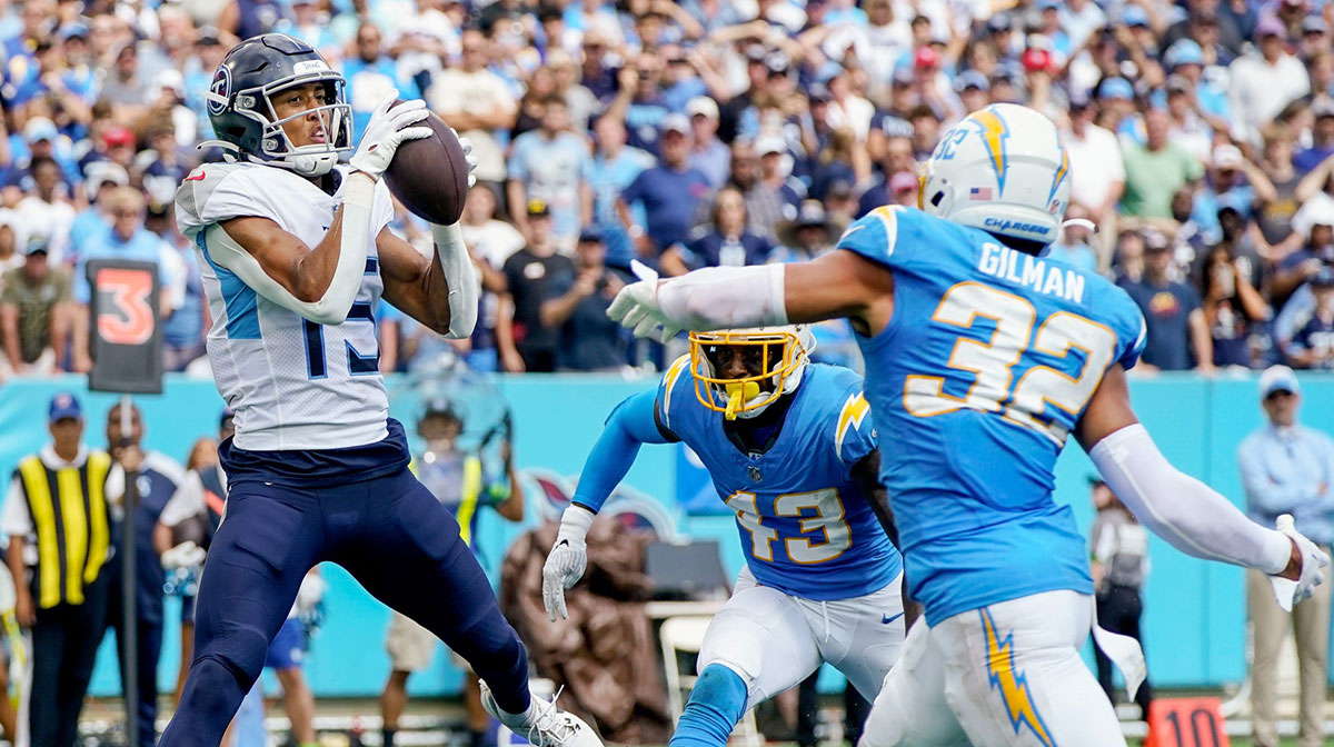 Tennessee Titans wide receiver Nick Westbrook-Ikhine (15) brings in a touchdown past Los Angeles Chargers cornerback Michael Davis (43) and safety Alohi Gilman (32) at Nissan Stadium in Nashville on Sept. 17, 2023. The Titans won their home opener 27-24 in overtime.