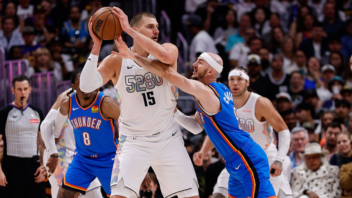 Denver Nuggets center Nikola Jokic (15) controls the ball under pressure form Oklahoma City Thunder guard Alex Caruso (9) in the second quarter during game six of the second round for the 2025 NBA Playoffs at Ball Arena.