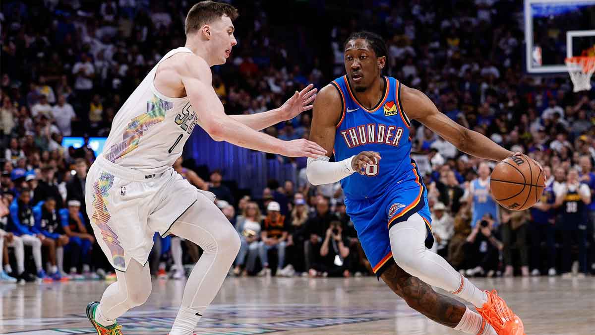 Thunder forward Jalen Williams (8) controls the ball as Denver Nuggets guard Christian Braun (0) guards in the second quarter during game six of the second round for the 2025 NBA Playoffs at Ball Arena