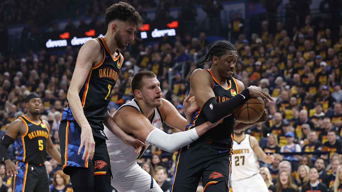 Nuggets center Nikola Jokic (15) loses the ball to Oklahoma City Thunder forward Jalen Williams (8) during the second quarter during game one of the second round for the 2025 NBA Playoffs at Paycom Center next to Thunder's Chet Holmgren