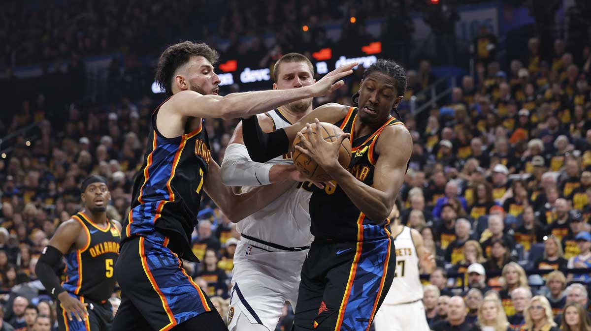 Thunder forward Jalen Williams (8) and forward Chet Holmgren (7) steal the ball from Denver Nuggets center Nikola Jokic (15) during the second quarter during game one of the second round for the 2025 NBA Playoffs at Paycom Center next to Thunder head coach Mark Daigneault