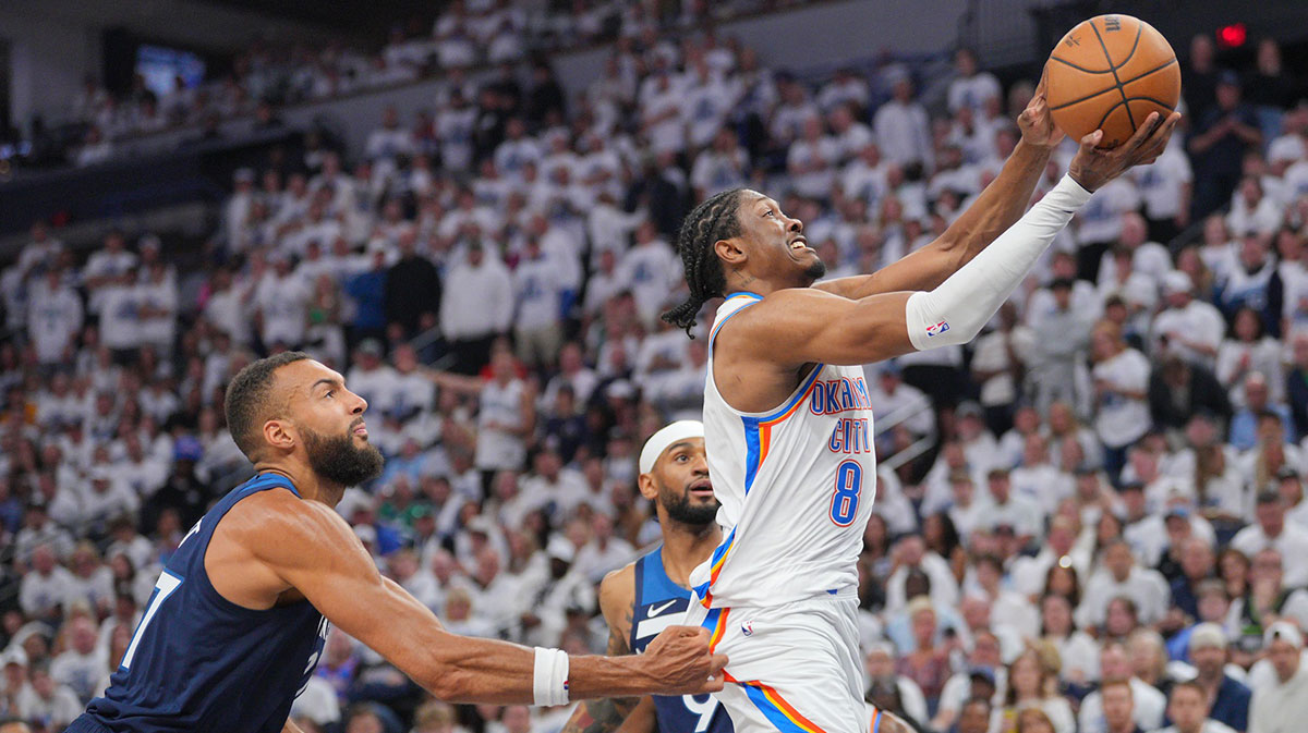 Thunder forward Jalen Williams (8) dribbles the ball past Minnesota Timberwolves center Rudy Gobert (27) during the first half in game three of the western conference finals for the 2025 NBA Playoffs at Target Center