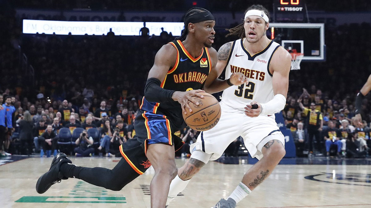 Thunder guard Shai Gilgeous-Alexander (2) drives around Denver Nuggets forward Aaron Gordon (32) during the second half during game one of the second round for the 2025 NBA Playoffs at Paycom Center