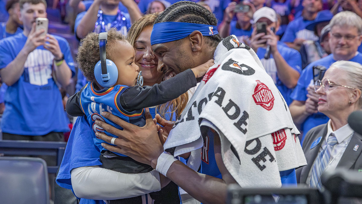 Thunder guard Shai Gilgeous-Alexander (2) hugs his son and wife after his team defeated the Denver Nuggets in game seven of the second round for the 2025 NBA Playoffs at Paycom Center