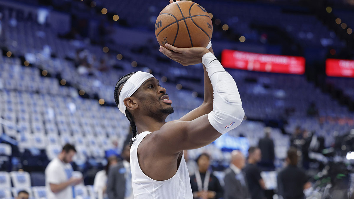 Thunder guard Shai Gilgeous-Alexander warms up before game one of the western conference finals against the Minnesota Timberwolves in the 2025 NBA Playoffs at Paycom Center with Nuggets' Nikola Jokic in the background