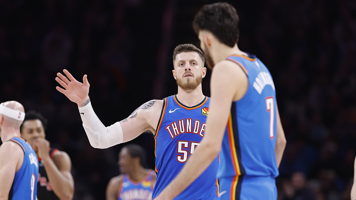 Thunder center Isaiah Hartenstein (55) gestures towards forward Chet Holmgren (7) after a play against the Toronto Raptors during the second half at Paycom Center