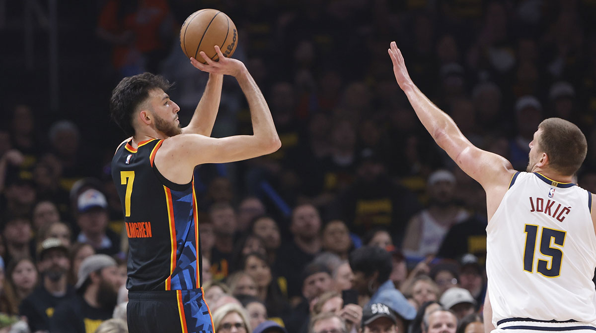 Thunder forward Chet Holmgren (7) shoots a three point basket as Denver Nuggets center Nikola Jokic (15) defends in the first quarter during game two of the second round for the 2025 NBA Playoffs at Paycom Center
