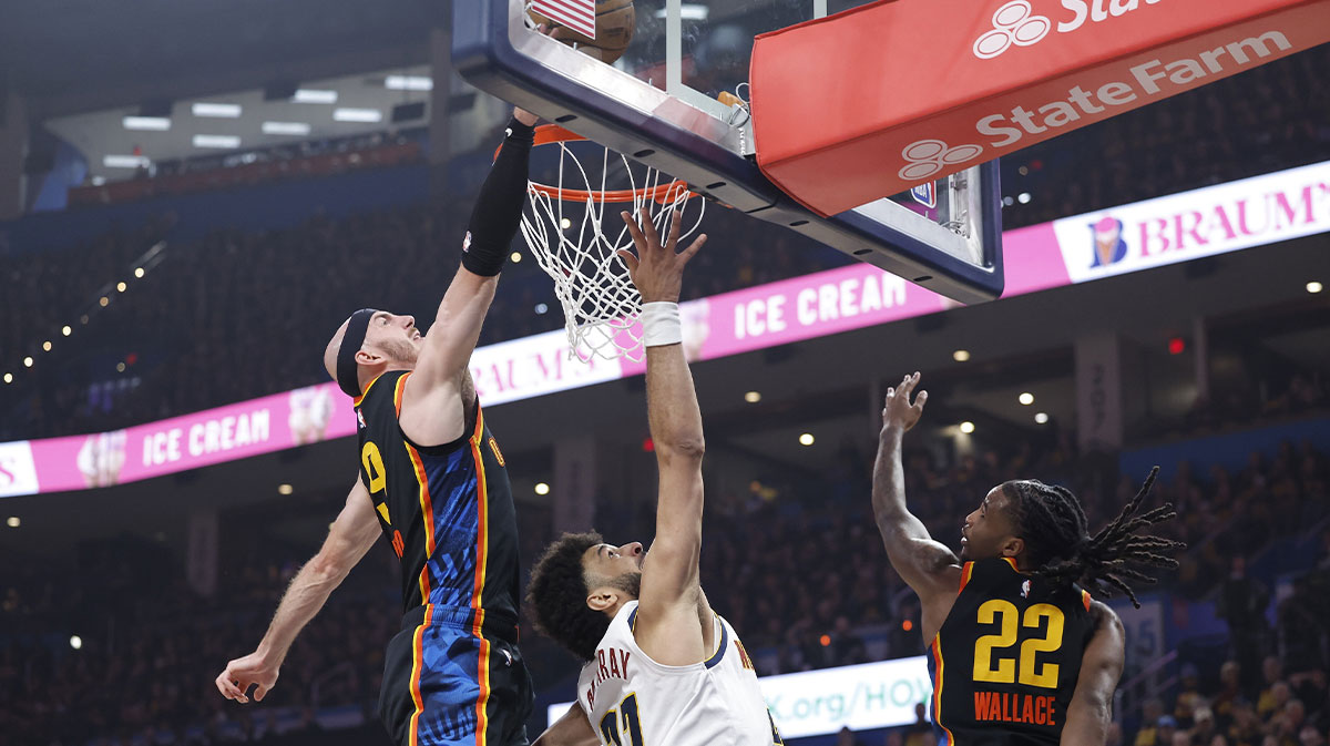Thunder guard Alex Caruso (9) blocks a shot by Denver Nuggets guard Jamal Murray (27)
