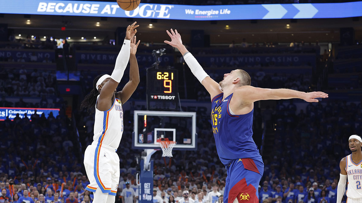 Thunder guard Luguentz Dort (5) shoots a three point basket as Denver Nuggets center Nikola Jokic (15) defends during the second half of game five of the second round for the 2025 NBA Playoffs at Paycom Center
