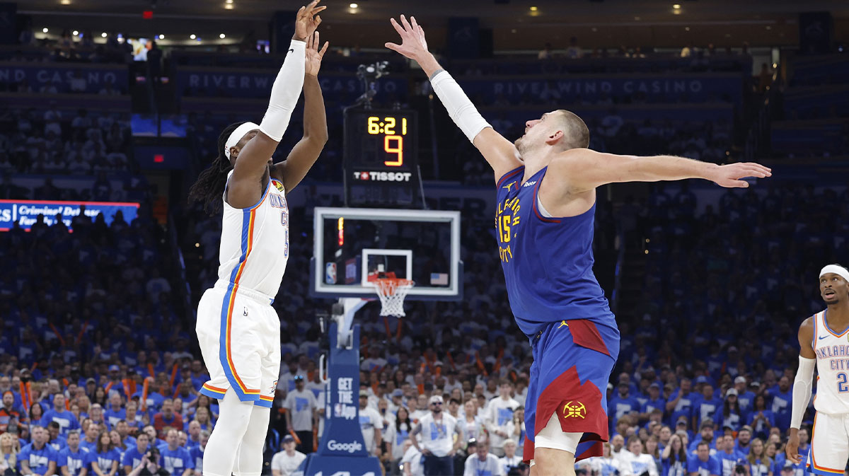 Thunder guard Luguentz Dort (5) shoots a three point basket as Denver Nuggets center Nikola Jokic (15) defends during the second half of game five of the second round for the 2025 NBA Playoffs at Paycom Center