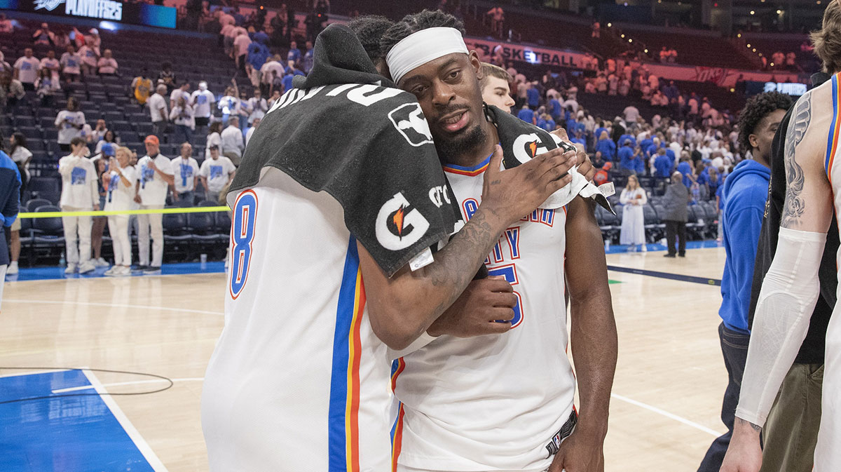 Thunder forward Jalen Williams (8) and guard Luguentz Dort (5) hug after their team defeated the Denver Nuggets during the second half of game five of the second round for the 2025 NBA Playoffs at Paycom Center with Thunder All-Star Shai Gilgeous-Alexander in the background