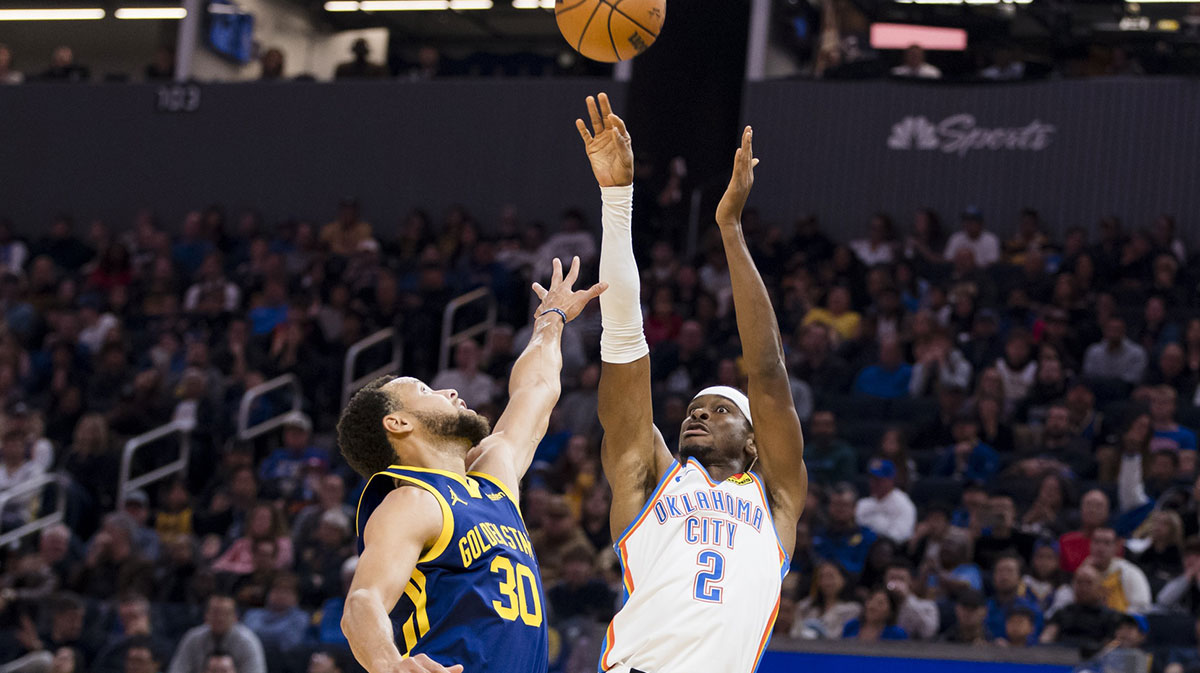 Oklahoma City Thunder guard Shai Gilgeous-Alexander (2) shoots over Golden State Warriors guard Stephen Curry (30) during the first half at Chase Center.