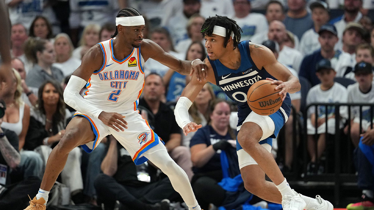 Minnesota Timberwolves guard Terrence Shannon Jr. (00) dribbles the ball against Oklahoma City Thunder guard Shai Gilgeous-Alexander (2) in the first half during game four of the western conference finals for the 2025 NBA Playoffs at Target Center.