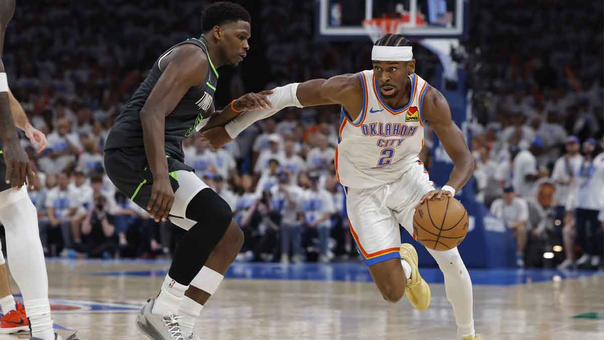 Oklahoma City Thunder guard Shai Gilgeous-Alexander (2) drives against Minnesota Timberwolves guard Anthony Edwards (5) in the fourth quarter during game one of the western conference finals for the 2025 NBA Playoffs at Paycom Center.