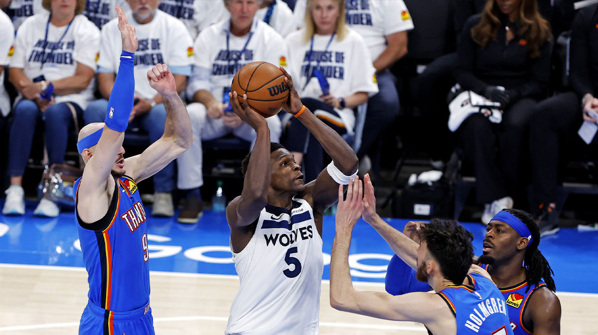 Timberwolves guard Anthony Edwards (5) drives to the basket against Oklahoma City Thunder guard Alex Caruso (9) during the third quarter in game five of the western conference finals for the 2025 NBA Playoffs at Paycom Center