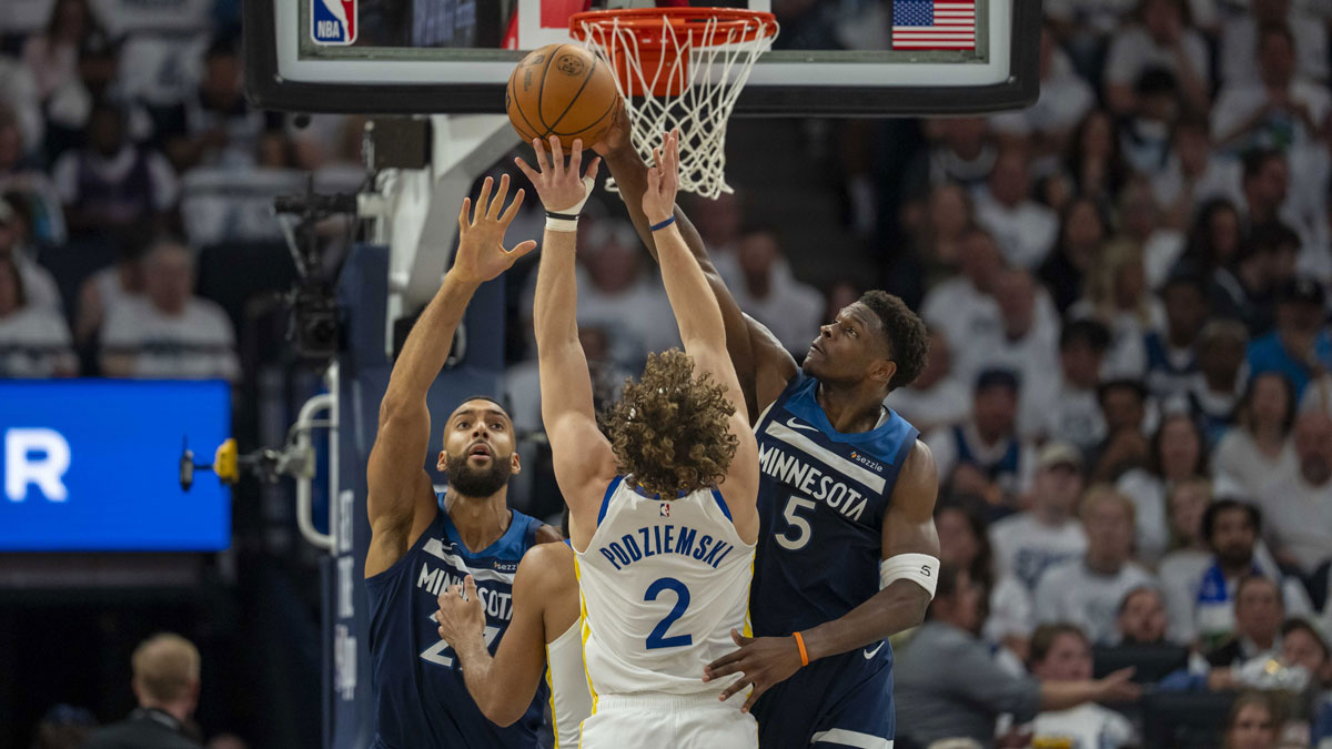 Minnesota Timberwolves guard Anthony Edwards (5) blocks a shot from Golden State Warriors guard Brandin Podziemski (2) as Minnesota Timberwolves center Rudy Gobert (27) plays defense in the first half during game five of the second round for the 2025 NBA Playoffs at Target Center.