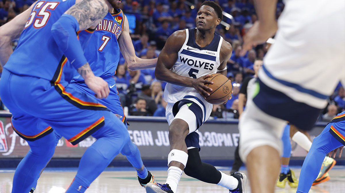 Minnesota Timberwolves guard Anthony Edwards (5) drives against Oklahoma City Thunder forward Chet Holmgren (7) in the third quarter during game two of the western conference finals for the 2025 NBA Playoffs at Paycom Center.