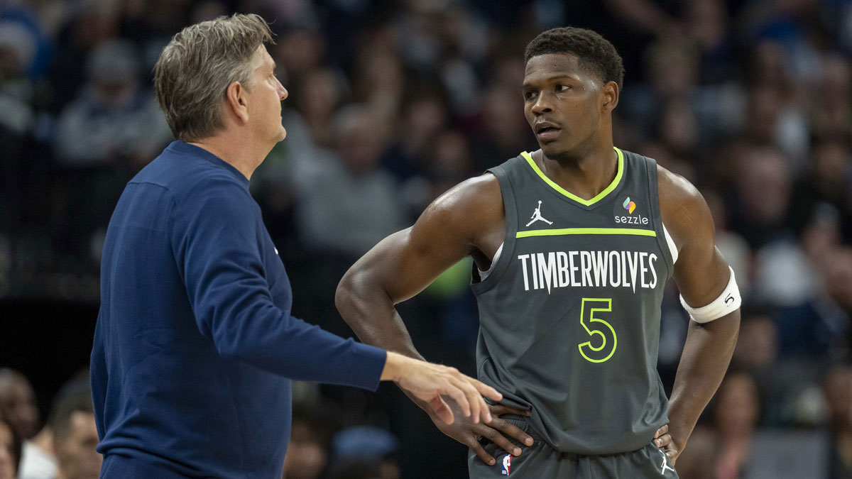 Minnesota Timberwolves head coach Chris Finch talks with Minnesota Timberwolves guard Anthony Edwards (5) against the Golden State Warriors in the first half at Target Center.