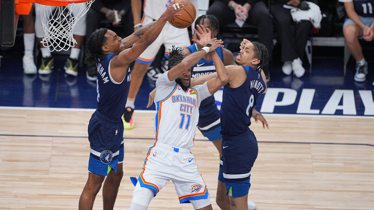 Oklahoma City Thunder guard Isaiah Joe (11) is blocked by Minnesota Timberwolves forward Josh Minott (8) and guard Rob Dillingham (4) during the second half in game three of the western conference finals for the 2025 NBA Playoffs at Target Center.