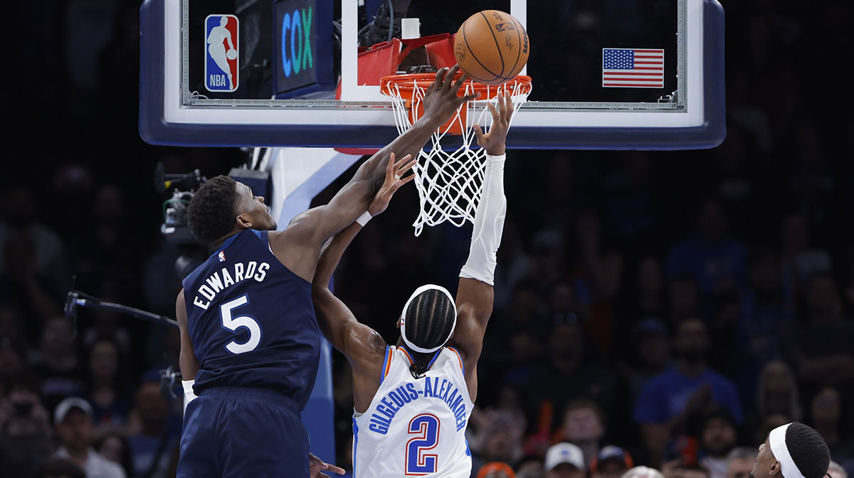 Minnesota Timberwolves guard Anthony Edwards (5) blocks a shot by Oklahoma City Thunder guard Shai Gilgeous-Alexander (2) during the second half at Paycom Center.