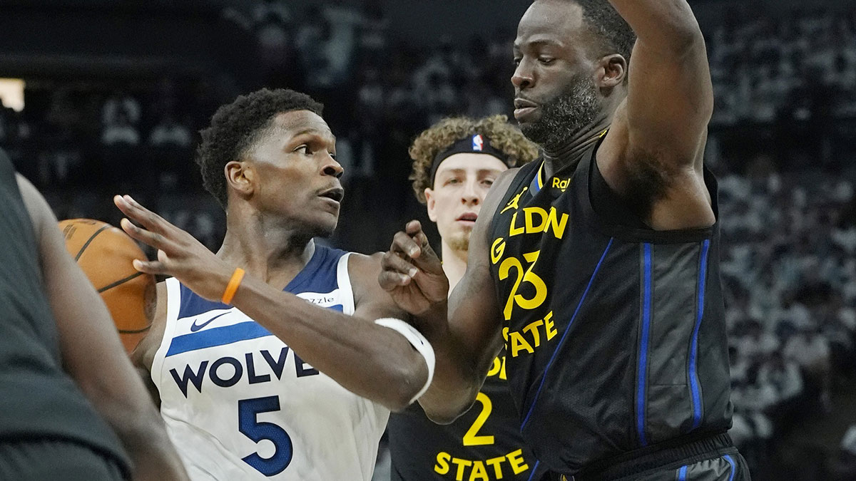 Minnesota Timberwolves guard Anthony Edwards (5) controls the ball against Golden State Warriors forward Draymond Green (23) in the first quarter during game one of the second round for the 2025 NBA Playoffs at Target Center.