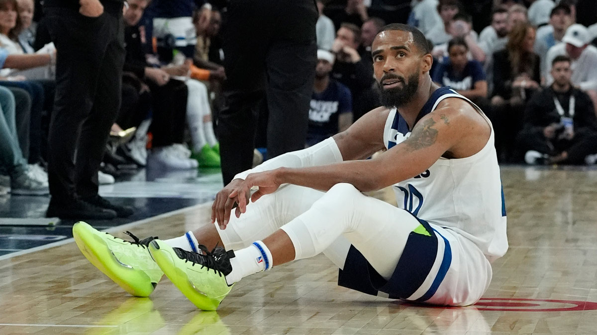 Minnesota Timberwolves guard Mike Conley (10) rests on the floor after taking a charge by a member of the Golden State Warriors in the third quarter during game one of the second round for the 2025 NBA Playoffs at Target Center.