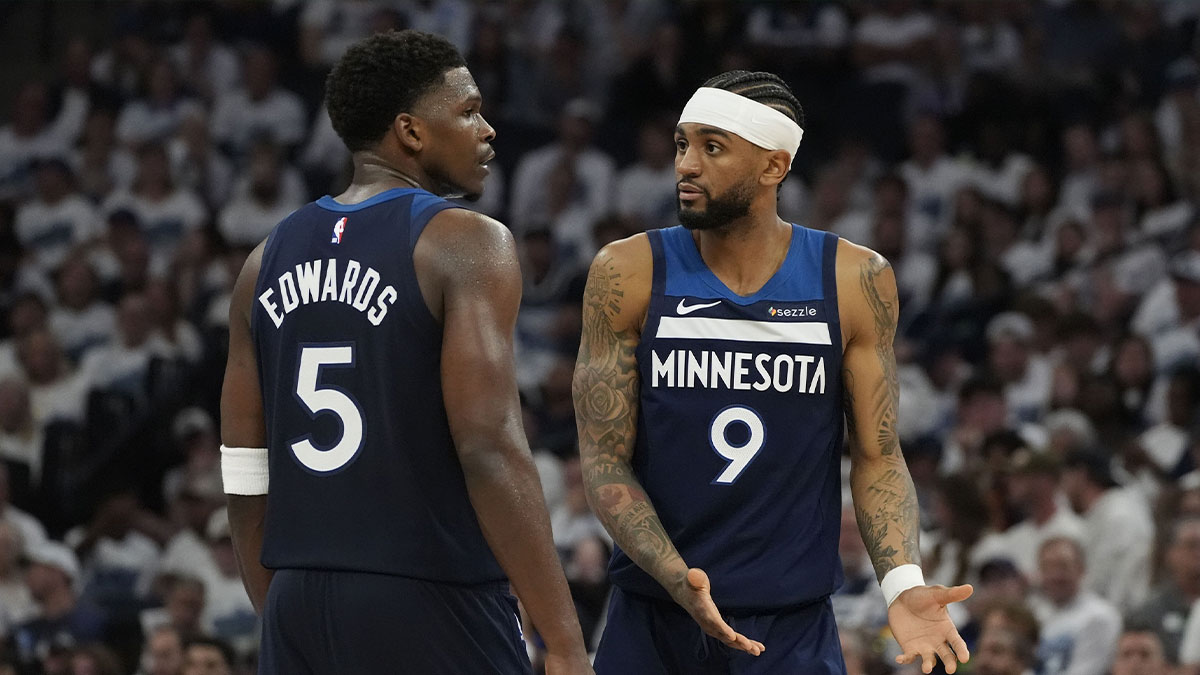 Timberwolves guard Nickeil Alexander-Walker (9) and guard Anthony Edwards (5) talk