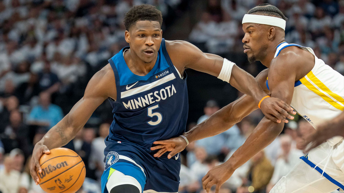 Minnesota Timberwolves guard Anthony Edwards (5) dribbles the ball past Golden State Warriors forward Jimmy Butler III (10) in the first half during game two of the second round for the 2025 NBA Playoffs at Target Center.