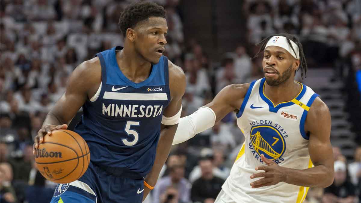 Minnesota Timberwolves guard Anthony Edwards (5) dribbles the ball past Golden State Warriors guard Buddy Hield (7) in the first half during game five of the second round for the 2025 NBA Playoffs