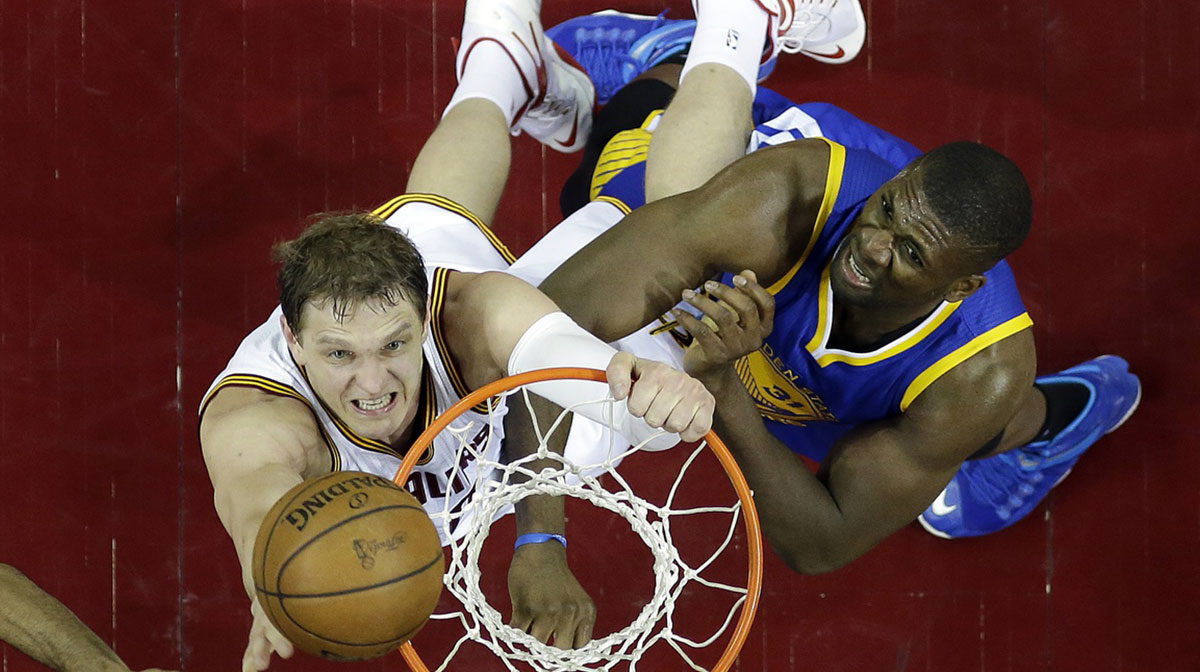 Cleveland Cavaliers center Timofey Mozgov (20) shoots the ball against Golden State Warriors center Festus Ezeli (31) in game six of the NBA Finals at Quicken Loans Arena.