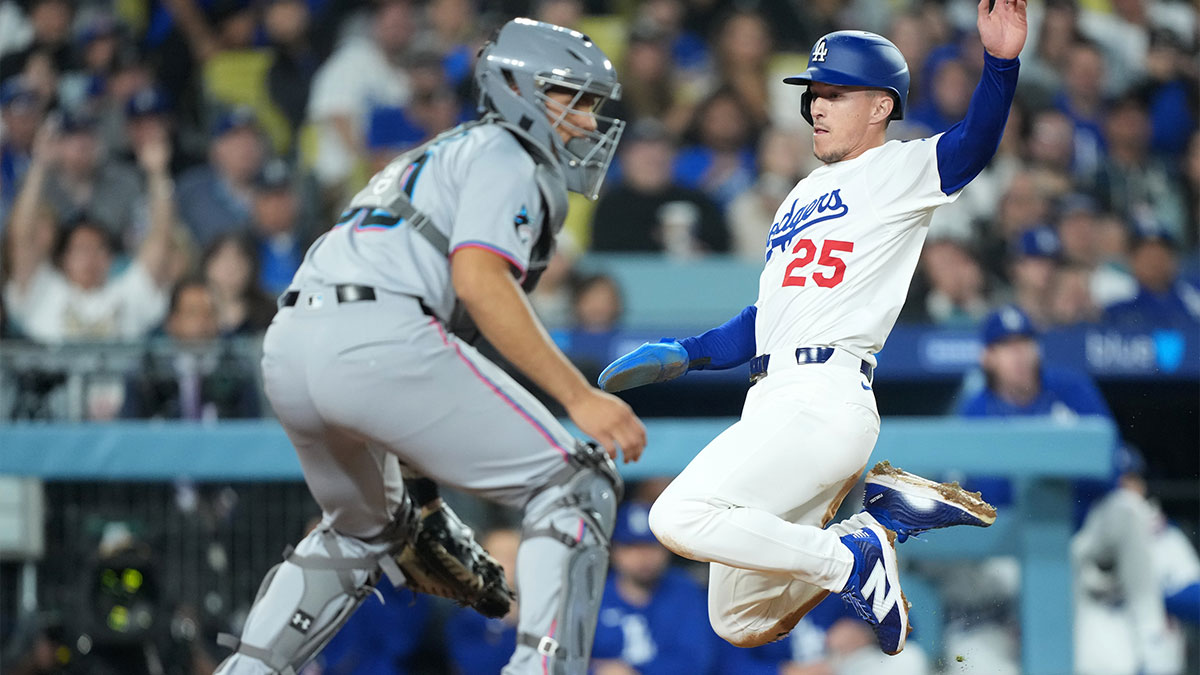 Los Angeles Dodgers second baseman Tommy Edman (25) scores against Miami Marlins catcher Agustin Ramirez (50) during the third inning at Dodger Stadium.