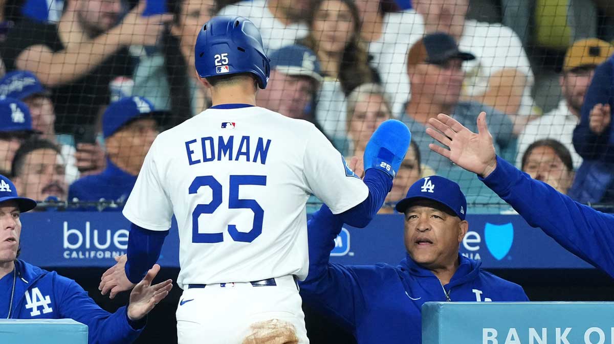 Apr 29, 2025; Los Angeles, California, USA; Los Angeles Dodgers second baseman Tommy Edman (25) celebrates with manager Dave Roberts (30) after scoring against the Miami Marlins during the third inning at Dodger Stadium. Mandatory Credit: Kirby Lee-Imagn Images