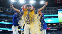 Toronto Blue Jays designated hitter Anthony Santander (25) gets the water bucket poured on him by first baseman Vladimir Guerrero Jr. (27) following a game against the San Diego Padres at Rogers Centre.