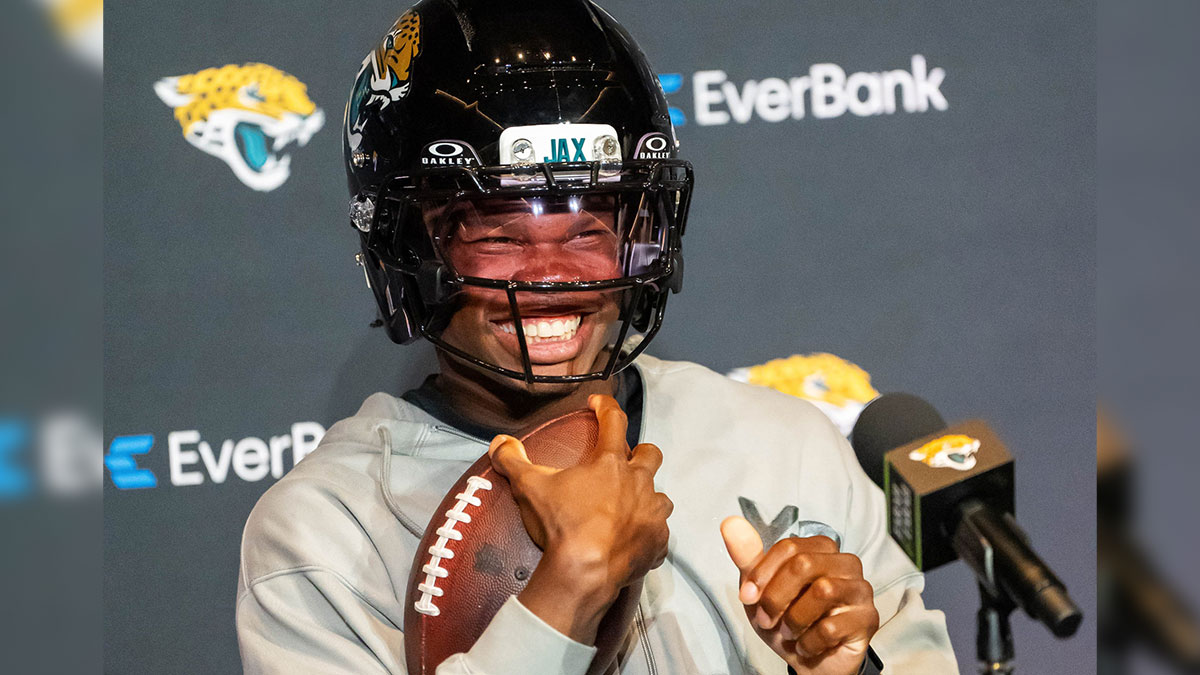 The Jacksonville Jaguars’ first-round pick, Colorado Buffaloes wide receiver and defensive back Travis Hunter sits in his chair with his helmet on and acting as if he was running after answering questions during a press conference.