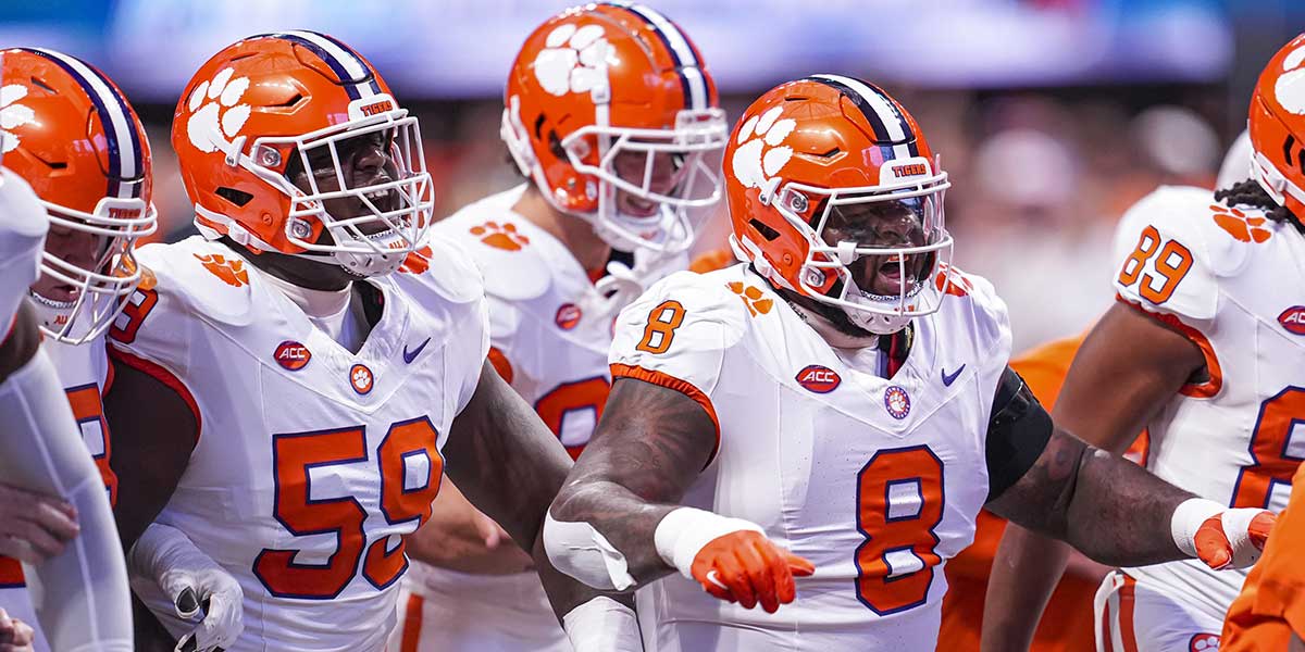 Clemson Tigers offensive lineman Dietrick Pennington (59) and defensive tackle Tre Williams (8) walk together on the field prior to the game against the Georgia Bulldogs at Mercedes-Benz Stadium.