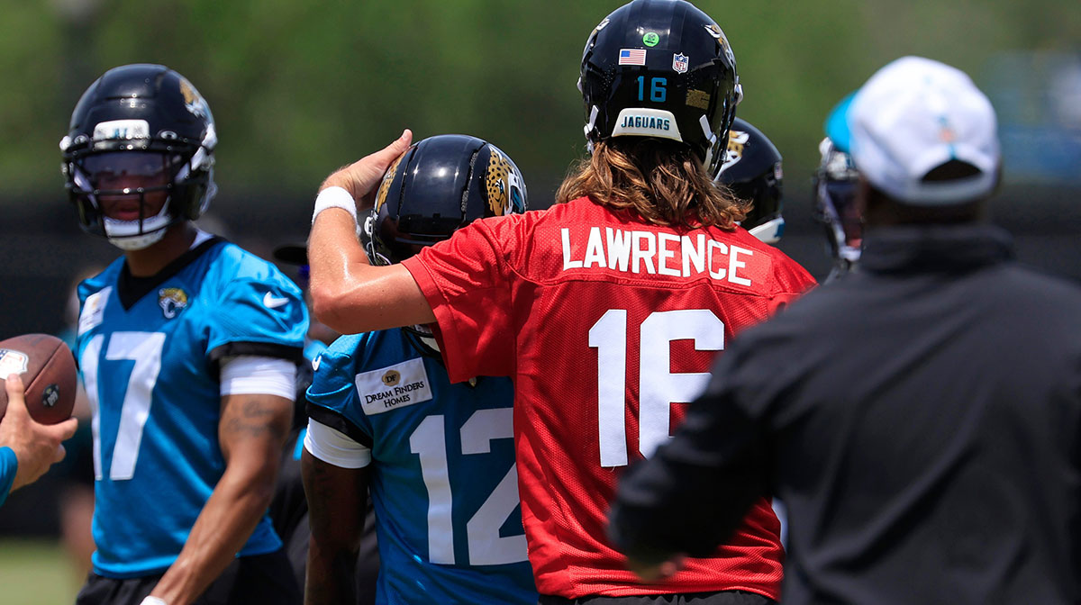 Jacksonville Jaguars quarterback Trevor Lawrence (16) taps wide receiver Travis Hunter (12) on the helmet as wide receiver Cam Camper (17) looks on during the first organized team activity at Miller Electric Center Monday, May 19, 2025 in Jacksonville, Fla.