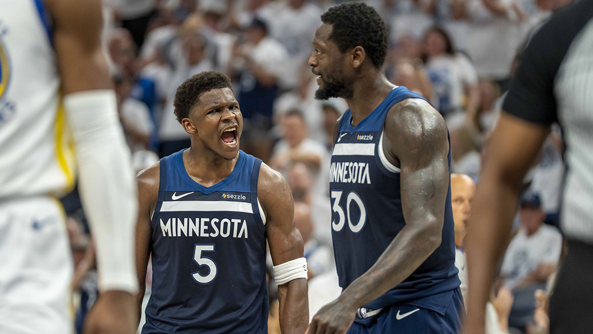 Minnesota Timberwolves guard Anthony Edwards (5) celebrates with Minnesota Timberwolves forward Julius Randle (30) after making a shot against the Golden State Warriors in the first half during game five of the second round for the 2025 NBA Playoffs at Target Center.