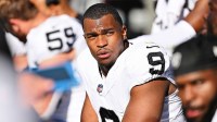 Las Vegas Raiders defensive end Tyree Wilson (9) takes a breather on the sidelines against the Chicago Bears at Soldier Field.
