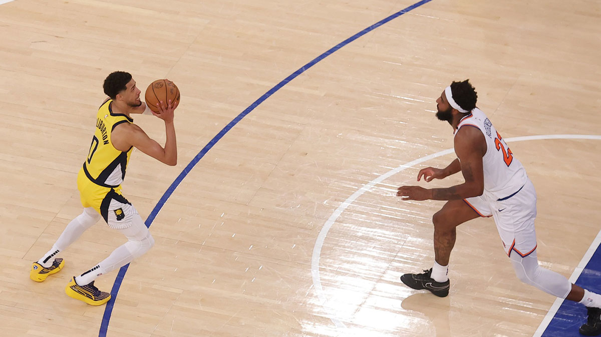 Indiana Pacers guard Tyrese Haliburton (0) shoots a game-tying two point shot to send the game to overtime in the fourth quarter against New York Knicks center Mitchell Robinson (23) during game one of the eastern conference finals for the 2025 NBA Playoffs at Madison Square Garden.
