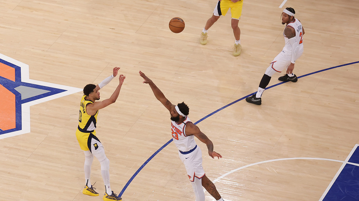 Indiana Pacers guard Tyrese Haliburton (0) shoots a game-tying two point shot to send the game to overtime in the fourth quarter against New York Knicks center Mitchell Robinson (23) during game one of the eastern conference finals for the 2025 NBA Playoffs at Madison Square Garden.