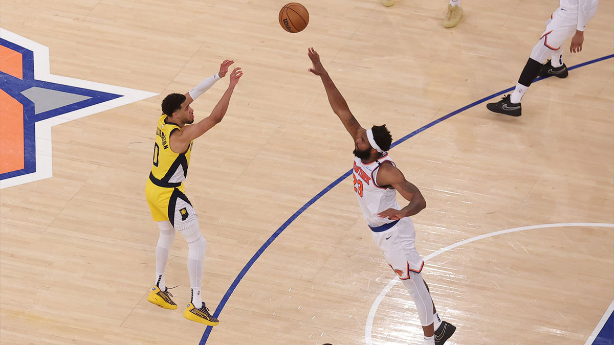 Indiana Pacers guard Tyrese Haliburton (0) shoots a game-tying two point shot to send the game to overtime in the fourth quarter against New York Knicks center Mitchell Robinson (23) during game one of the eastern conference finals for the 2025 NBA Playoffs at Madison Square Garden.