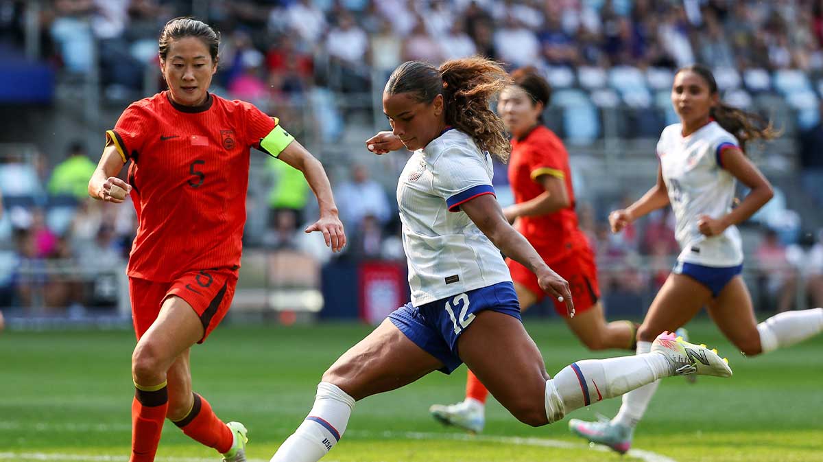 U.S. Women's National Team forward Michelle Cooper (12) shoots the ball against China PR defender Wu Haiyan (5) during the first half at Allianz Field.