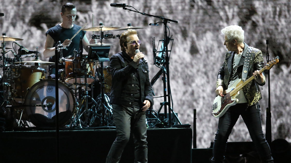 U2 members Larry Mullen Jr, who made his return to the stage from his health issues and after his recovery from injury, with Bono, and Adam Clayton on the Joshua Tree Tour in 2017.
