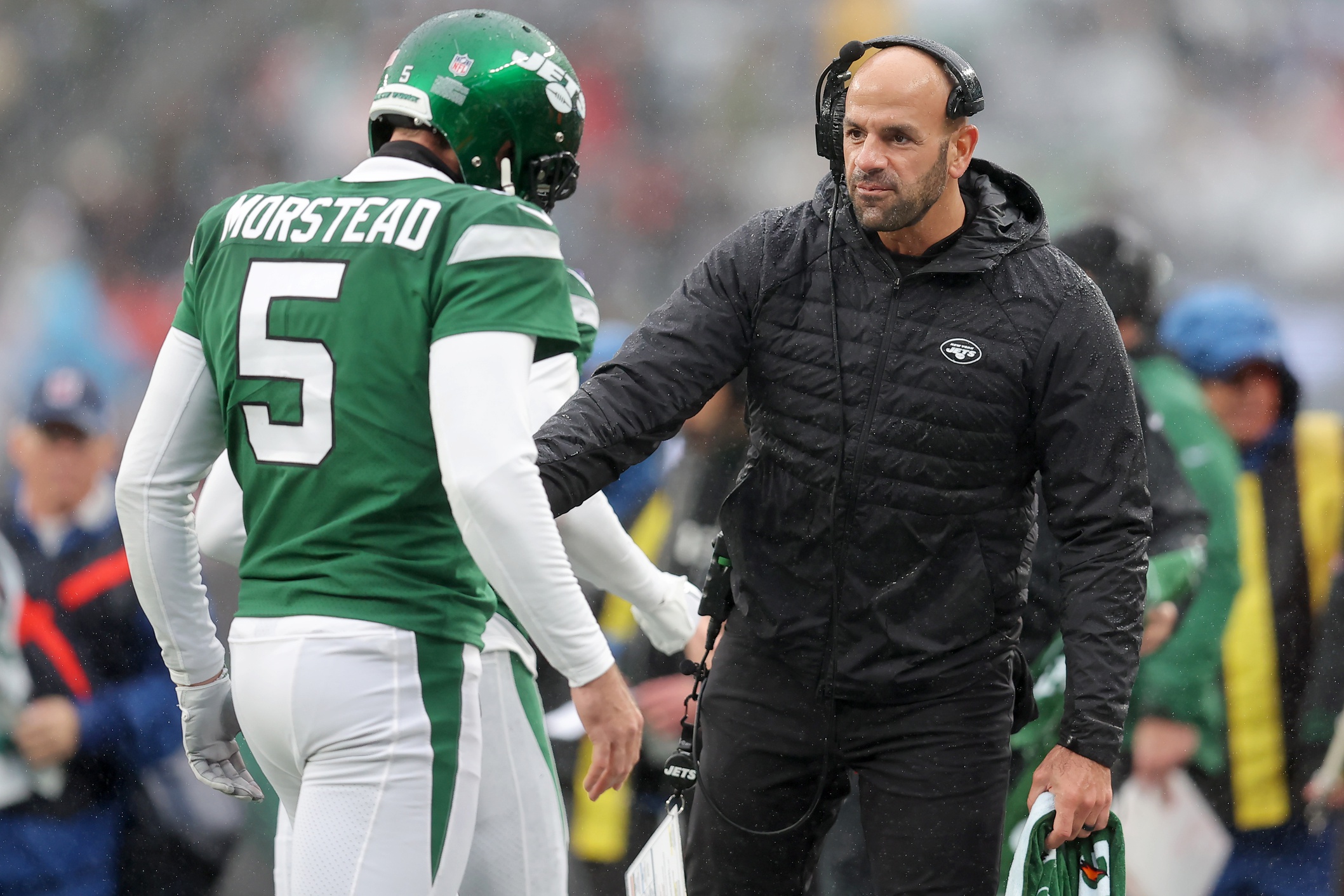New York Jets head coach Robert Saleh greets punter Thomas Morstead (5) as he returns to the sideline after a punt against the Atlanta Falcons during the first quarter at MetLife Stadium.