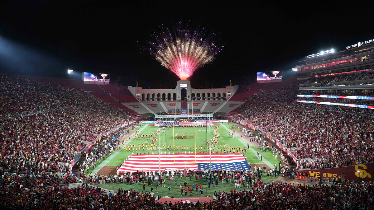 A general overall view of a United States flag and fireworks during the playing of the national anthem before the game between the Southern California Trojans and the Stanford Cardinal at United Airlines Field at Los Angeles Memorial Coliseum.