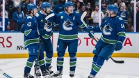 Vancouver Canucks forward Jake DeBrusk (74), forward Brock Boeser (6), defenseman Quinn Hughes (43) and forward Aatu Raty (54) celebrate DeBrusk’s goal against the San Jose Sharks in overtime at Rogers Arena.